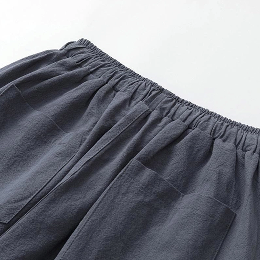 Close-up of meditation pants waist and side pockets - dark gray cotton linen fabric with elastic waistband showing functional pocket placement and thick textured material