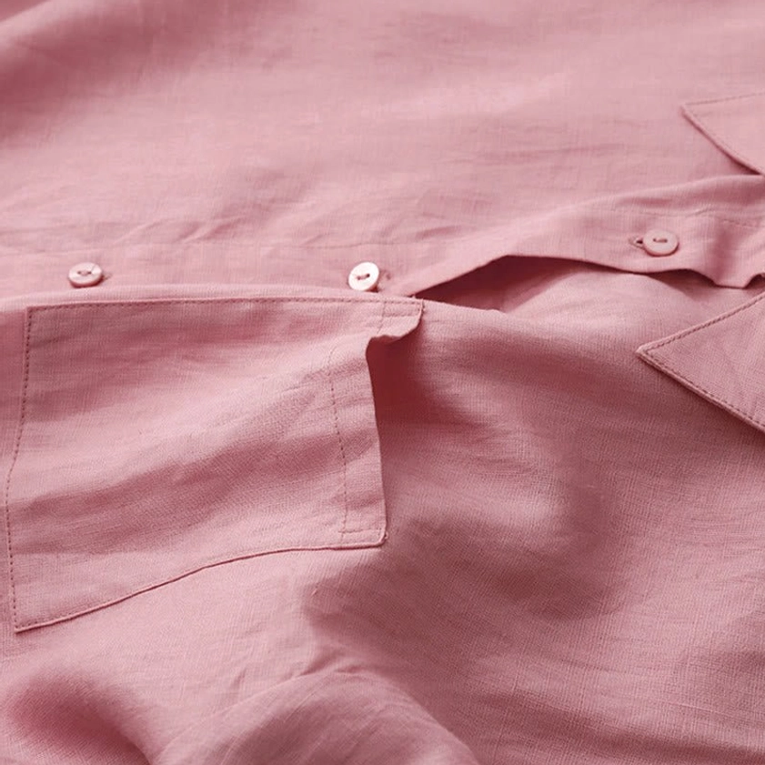 Close-up of meditation shirt chest pocket and front button placket showing subtle fabric grain