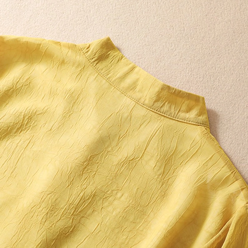 Stand collar detail of yellow crinkled meditation tunic top showing traditional neckline design and fabric texture