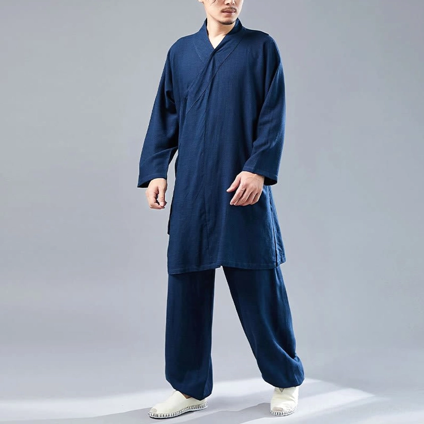 Full-body presentation of man in steel blue Buddhist meditation Tai Chi clothing