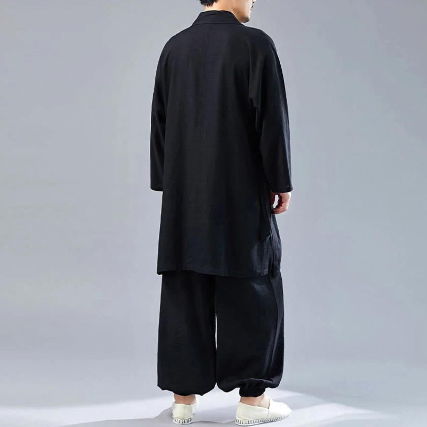 Detail of black meditation uniform fabric and V-neck construction showing quality craftsmanship