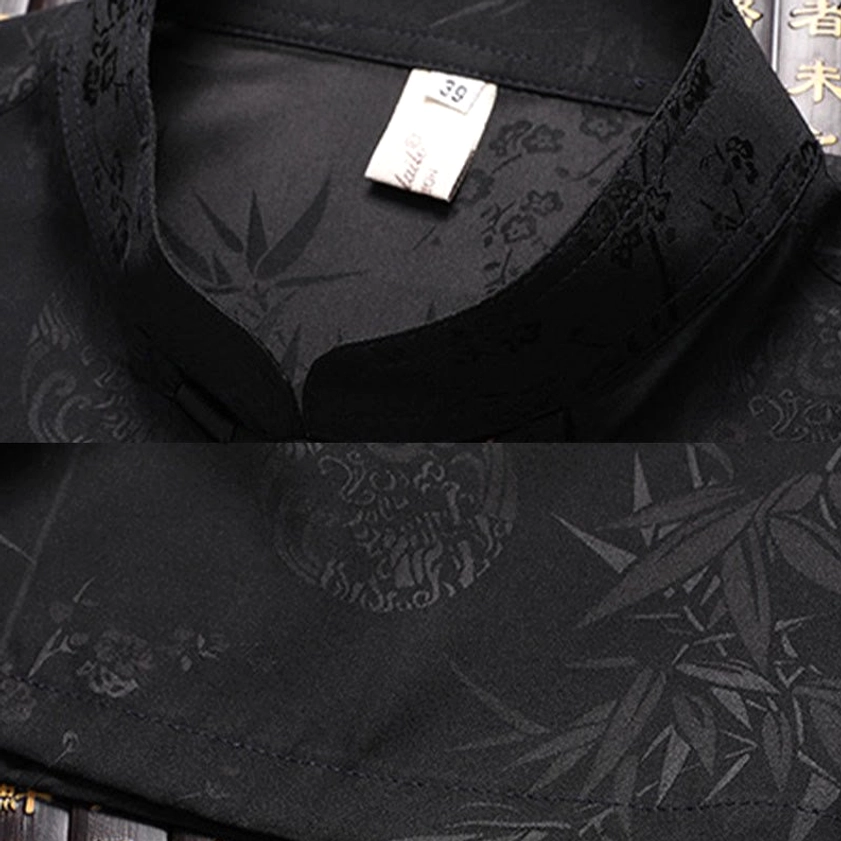 Men's traditional tang suit ensemble displaying bamboo pattern jacquard fabric and black pants pairing