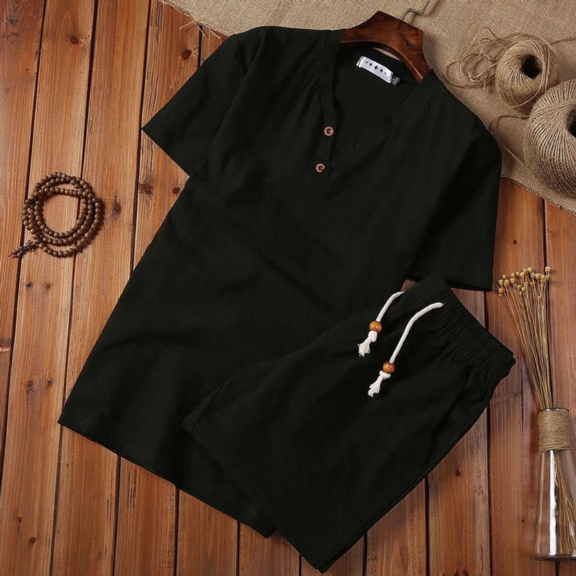 Black cotton linen men's meditation suit with henley collar top and drawstring shorts, flat lay view
