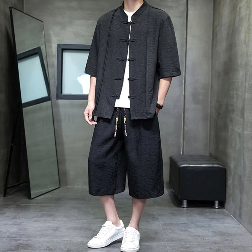 Men's black two-piece meditation suit showing mandarin collar and functional design