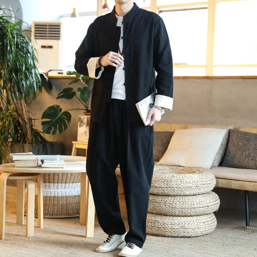 Men's black Buddhist Zen Tang suit with traditional frog button design for mindful living