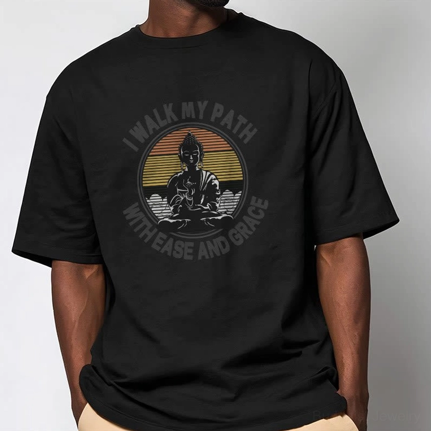 Man wearing black Buddhist ease and grace t-shirt with khaki pants casual street style