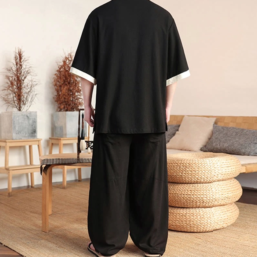 Back view of black men's Buddhist meditation linen suit showing wide-leg pants fit
