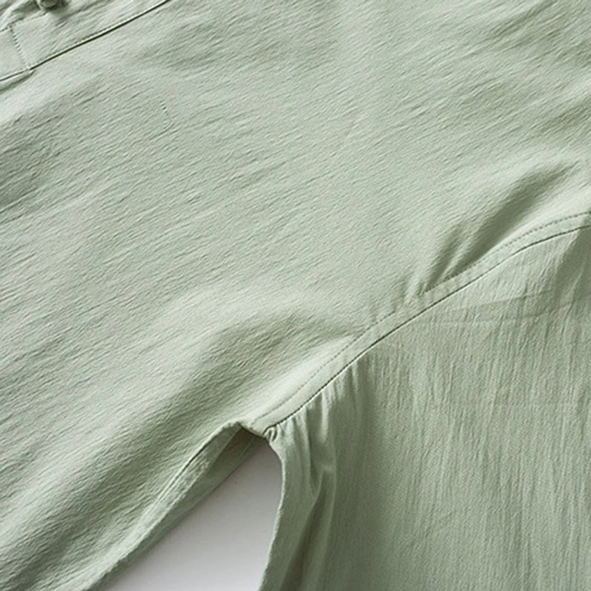 Men's Buddhist meditation suit back view showing three-quarter sleeves, frog buttons, and tapered drawstring pants silhouette