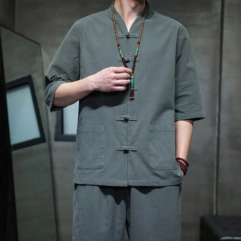 Men's Buddhist meditation cotton linen tang suit top close-up with stand collar, frog buttons, and beaded meditation accessories