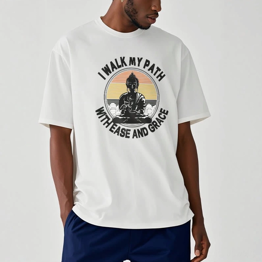 Man wearing cream white Buddhist ease and grace t-shirt with navy pants casual daily outfit