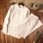 Men's beige linen meditation clothing set with long sleeve top and pants featuring traditional frog buttons - overhead flat lay view