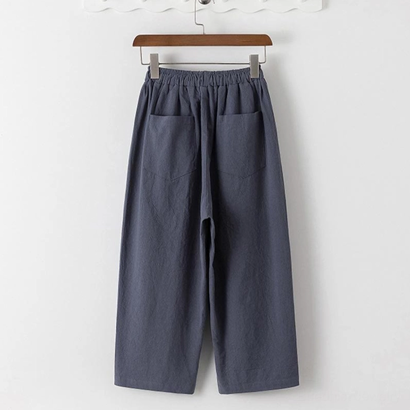 Men's Buddhist meditation cropped pants front flat lay - dark gray 7/8 length pants with dual side pockets and elastic waistband, showing practical functional design