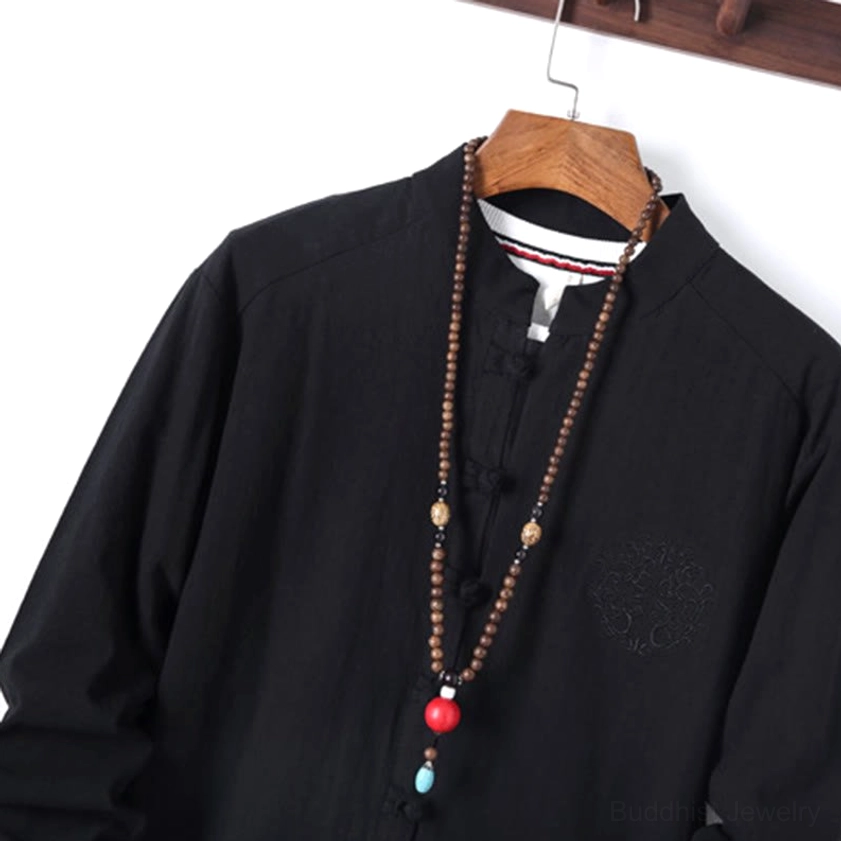 Close-up front view of mandarin collar frog button closure on meditation shirt with subtle chest embroidery detail