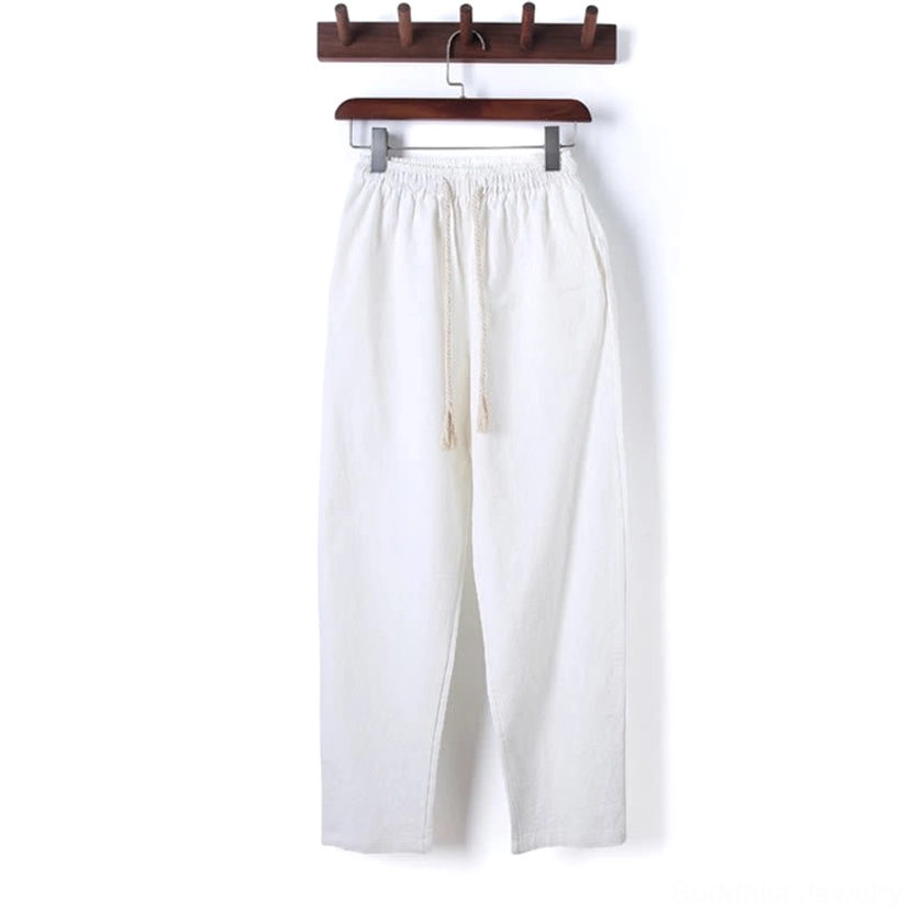 Firebrick red meditation pants with natural waist and elastic drawstring, side hanging view