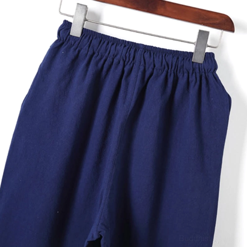 Close-up of meditation pants pocket detail and leg seam construction on cotton fabric