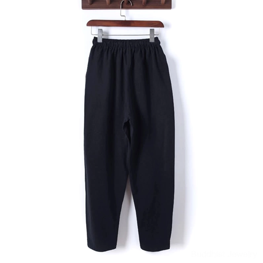 Side view of meditation pants showing simple silhouette, elastic waistband, and relaxed fit design
