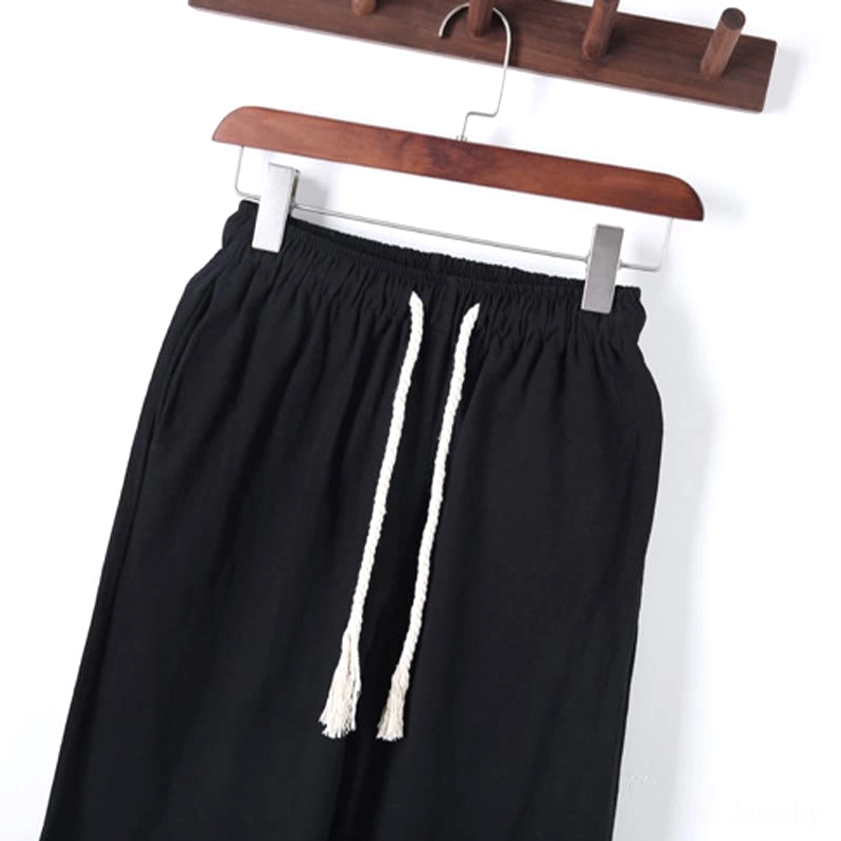 Close-up detail of meditation pants waist with white braided drawstring and elastic waist structure