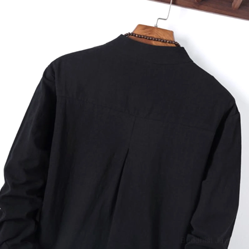 Back view close-up of pleated meditation shirt showing matte woven cotton fabric texture and curved hem design