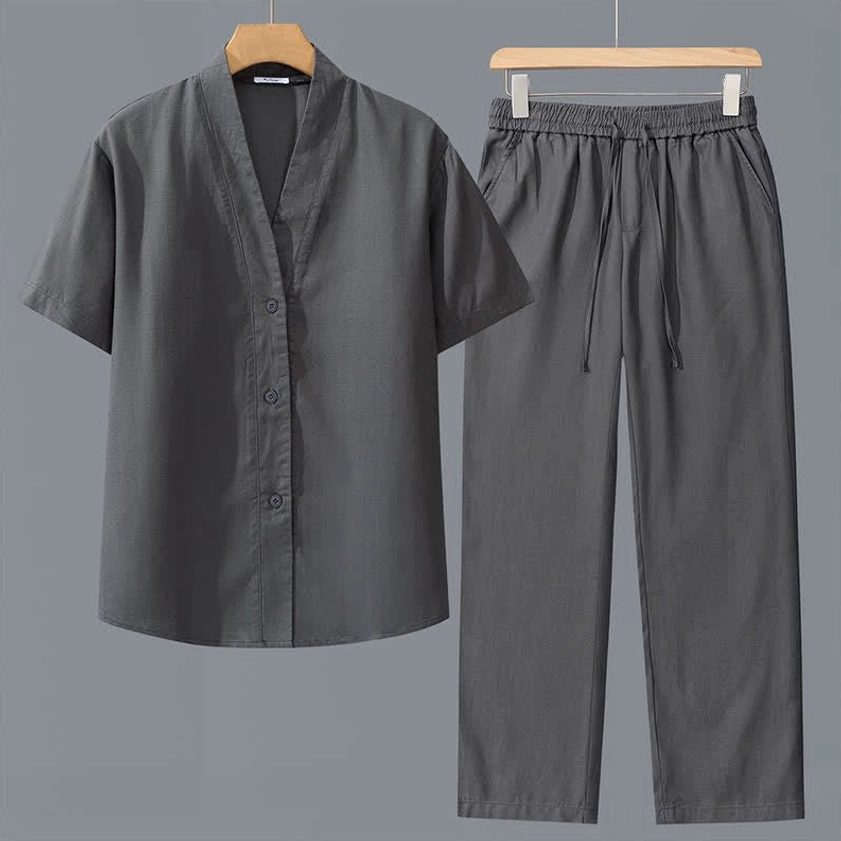 Dark gray men's meditation shirt and pants set flat lay front view with V-neck short sleeves and drawstring waist