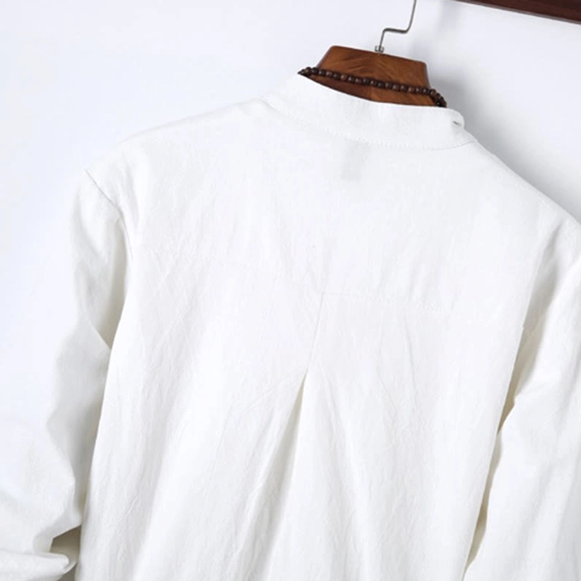 Close-up detail of royal blue meditation shirt mandarin collar with decorative embroidery accent