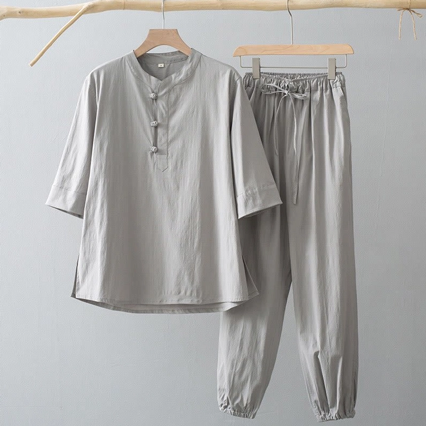 Men's gray Buddhist-inspired meditation suit with stand collar frog buttons, three-quarter sleeves, and tapered drawstring pants