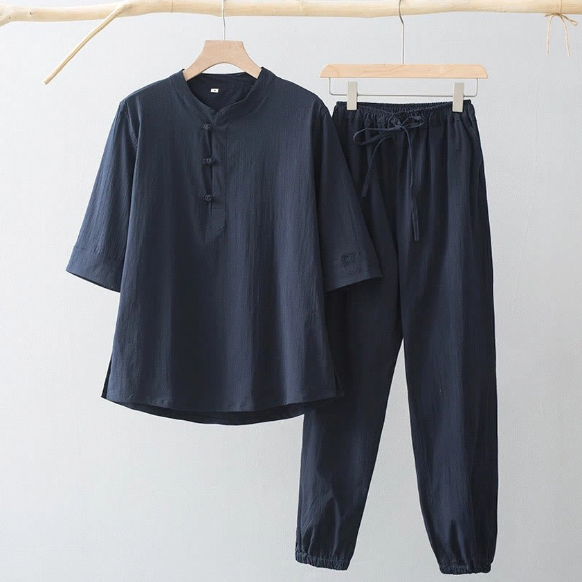 Navy blue men's meditation suit with cotton-linen texture, traditional frog buttons, three-quarter sleeves, and drawstring waist pants