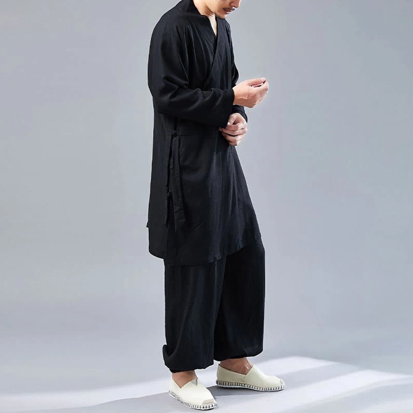 Side pose wearing black cotton-linen Tai Chi meditation uniform showing relaxed fit