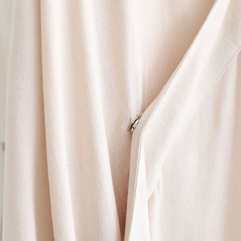 Detail of steel blue meditation uniform fabric quality and V-neck collar design