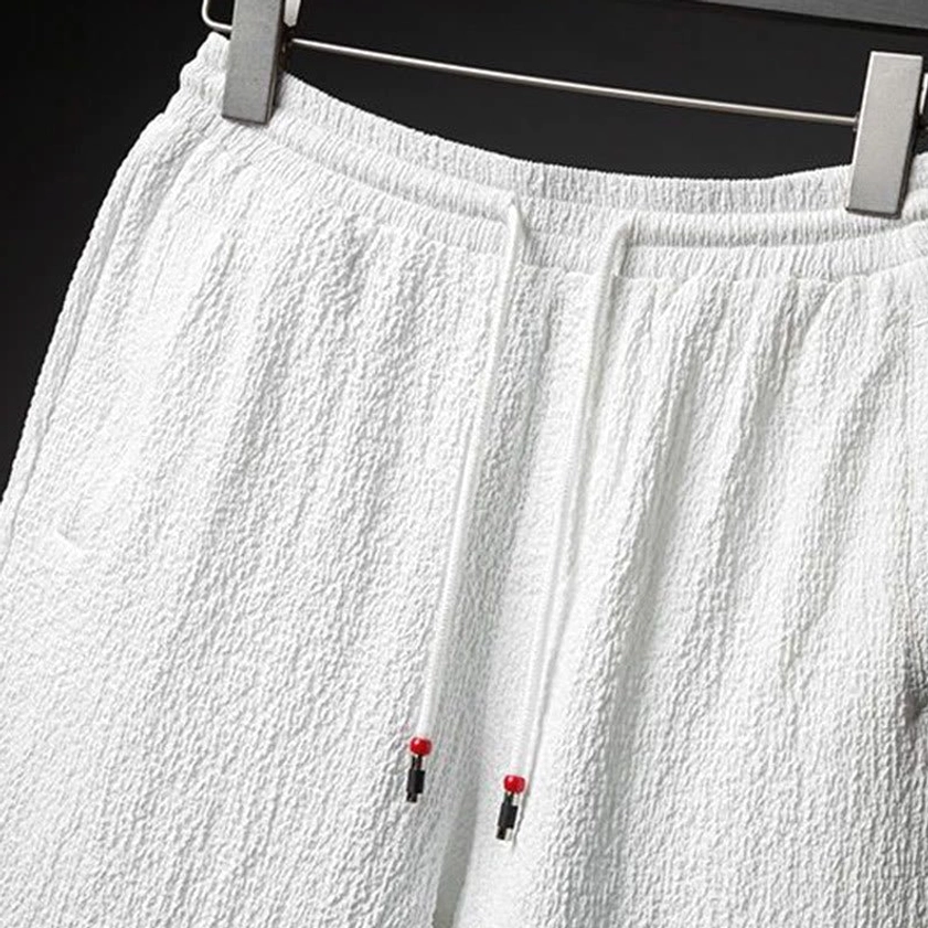 Men's textured stand collar half-sleeve shirt and elastic waist pants, close-up showing fabric quality and garment construction