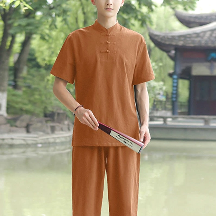 Men's brown Zen Tai Chi cotton linen uniform with stand collar frog buttons in Chinese garden setting