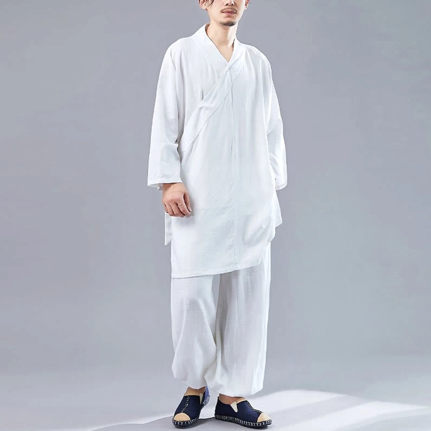 Front full-body view of man wearing white V-neck Buddhist meditation uniform with minimalist design