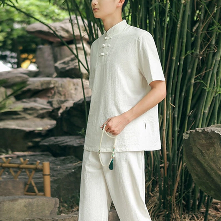 Men's white Zen Tai Chi meditation uniform side view in bamboo garden with relaxed fit