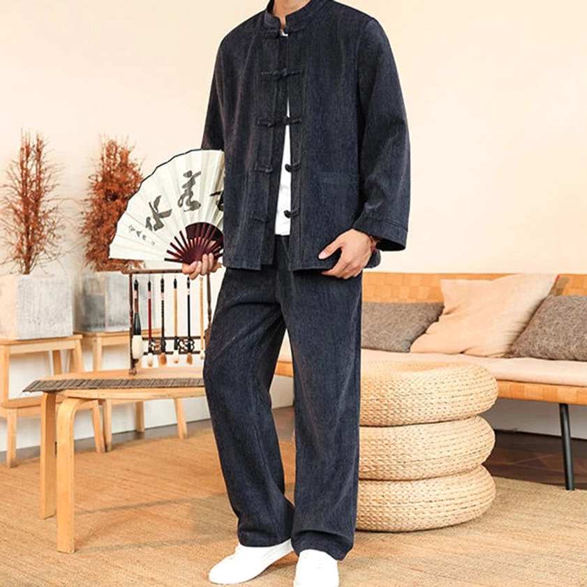 Men's Tang suit three-quarter view with Chinese fan prop and frog button jacket detail