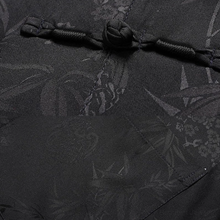 Close-up detail of men's tang suit frog buttons and traditional stand collar craftsmanship