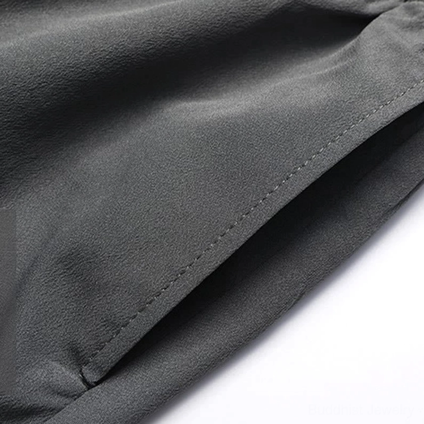 Men's Tang suit pants pocket design with embroidery accent, demonstrating functional and decorative stitching