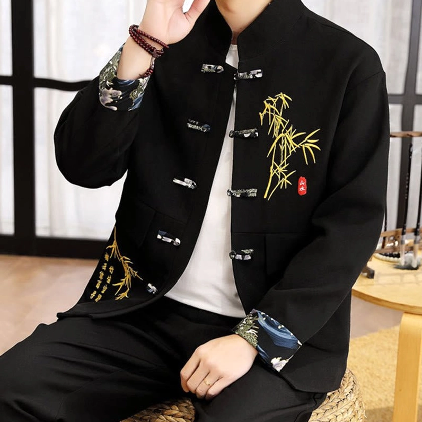 Men's Tang suit two-piece sitting view - detail of patterned contrast cuffs and seated posture