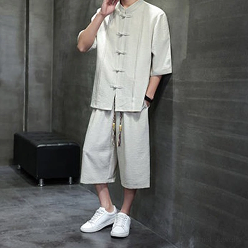Men's Buddhist-inspired tang suit three-quarter angle view showing frog button details and mandarin collar