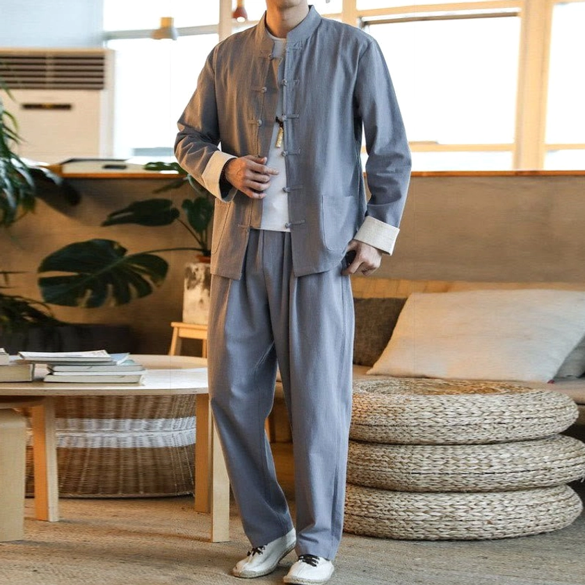 Men's gray Buddhist Zen Tang suit set with frog buttons, front three-quarter view in home leisure setting