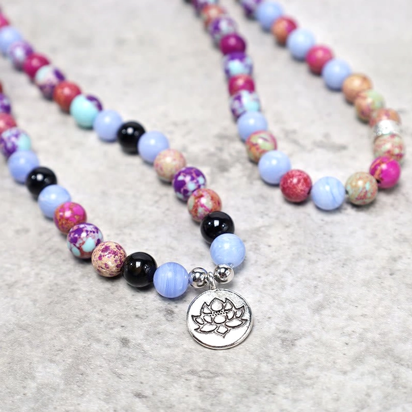Purple Miano Real stone mala beads arranged showing varied earthy purple tones and natural characteristics of each bead