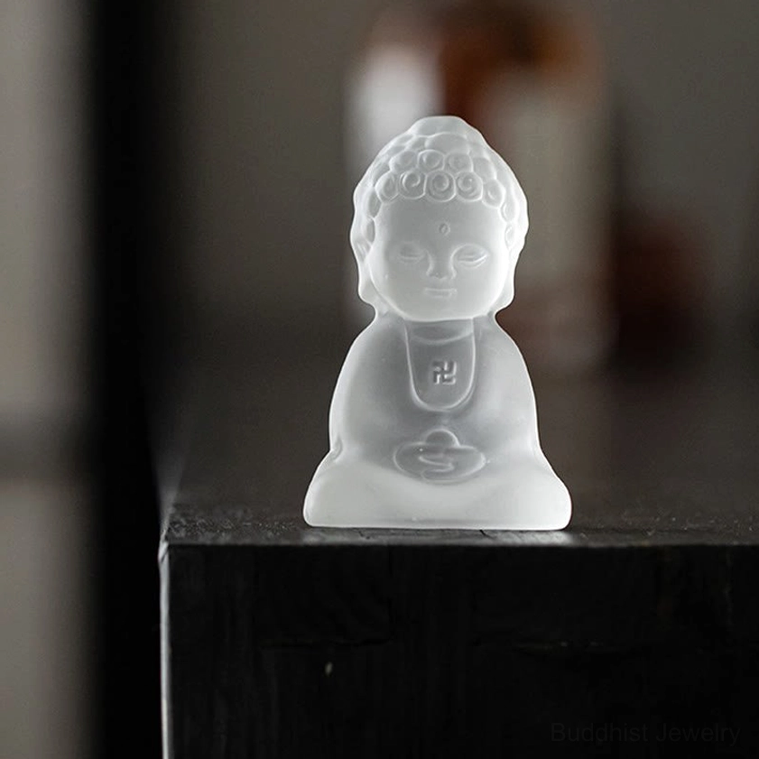 Miniature Buddhist desk decoration statue showing classic Buddha posture on wooden shelf