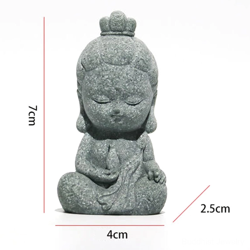 Seated mini Buddha statue with rough stone texture and closed eyes on white background, perfect for size comparison and display