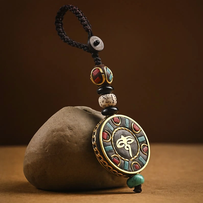 Mini Buddhist Wisdom Eye amulet keychain with small enamel brass pendant and beaded rope strap