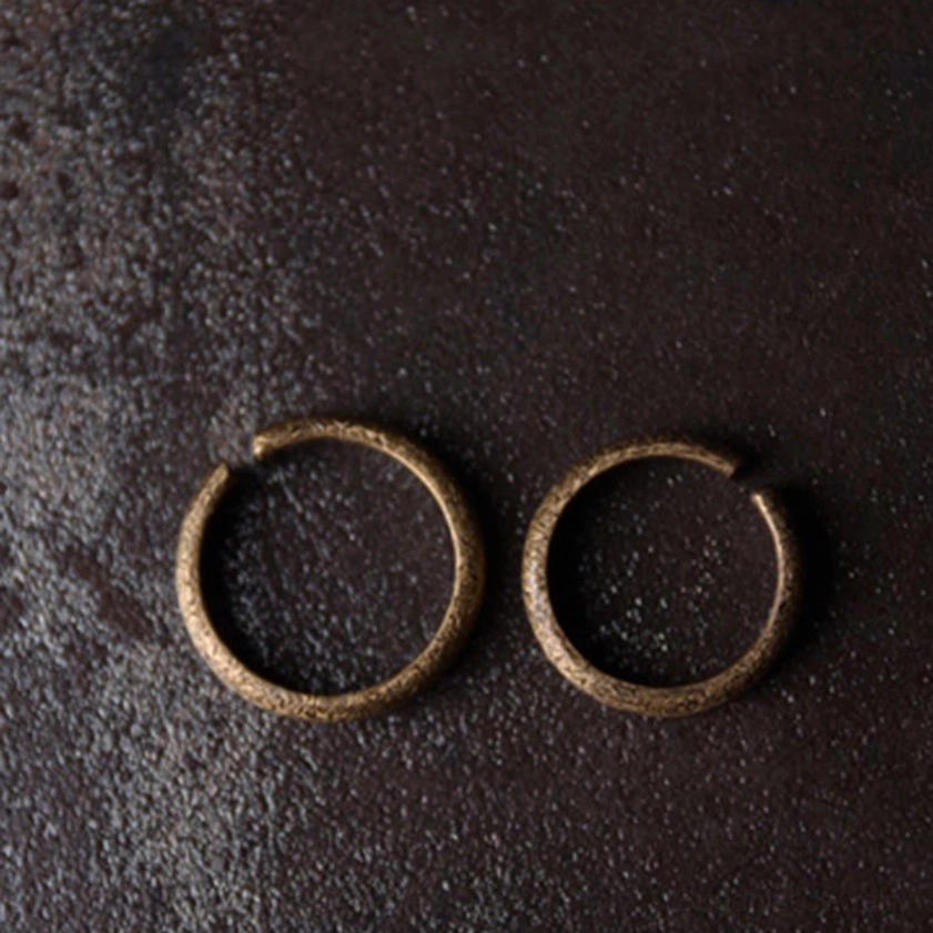Slim minimalist vintage copper Buddhist rings with simple open notch design, flat overhead perspective
