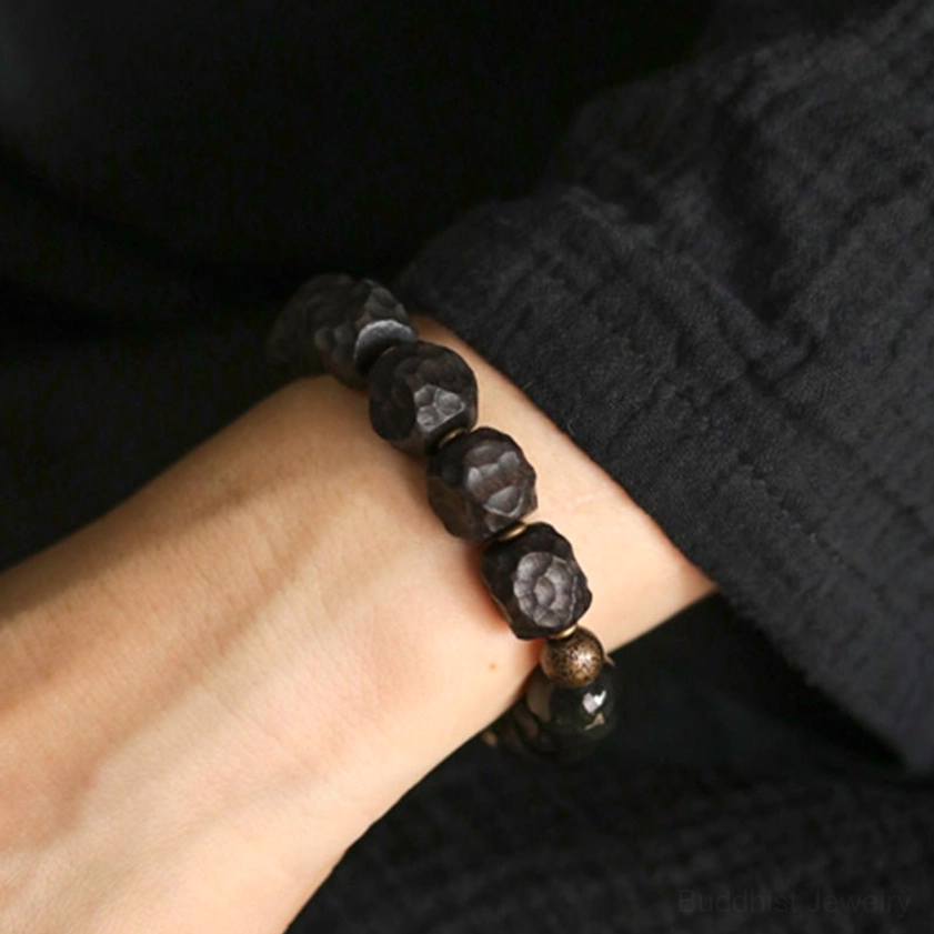 Minimalist black obsidian ebony wood couple bracelet - close-up side view highlighting natural bead texture and elastic string