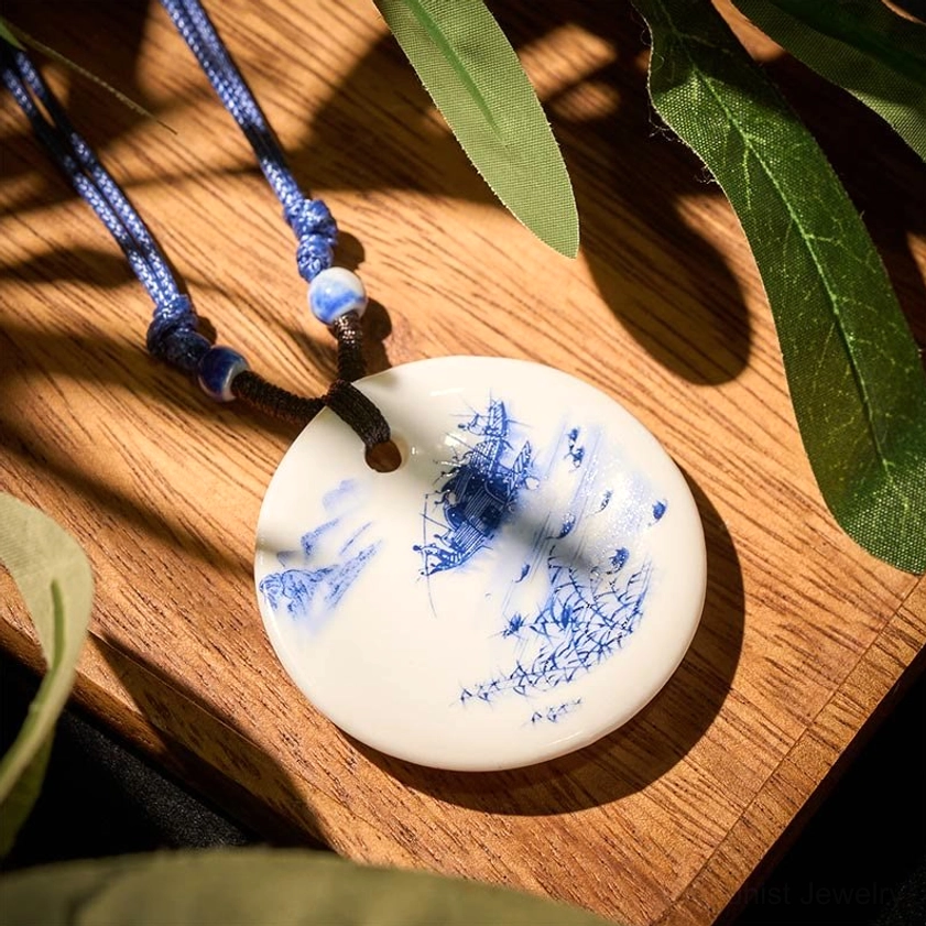 Misty river boat scenery ceramic pendant necklace overhead flat lay showing artistic boat design