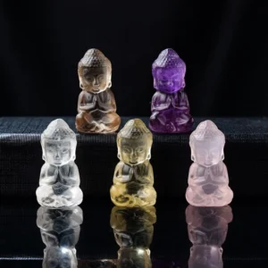Multi-color carved Buddha crystal pendant collection - amethyst, pink crystal, white crystal, citrine, and smoky quartz Buddha figurines in flat lay display