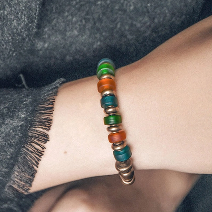 Mixed glass and copper beaded bracelet stack view showing colorful matte glass beads with copper spacer accents