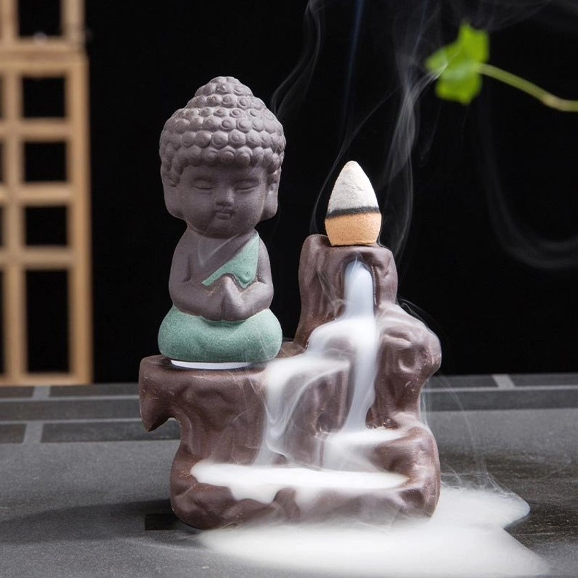 Multiple color variants of ceramic monk backflow incense burner in blue green yellow and red options