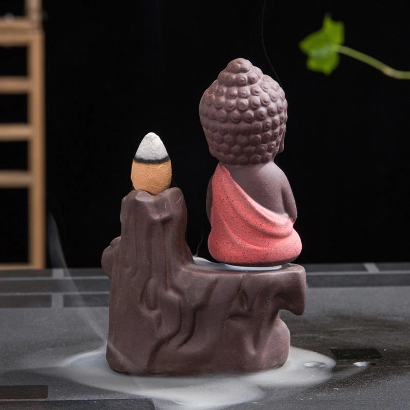 Rear view of handcrafted ceramic monk incense burner showing back of meditating figure and base design
