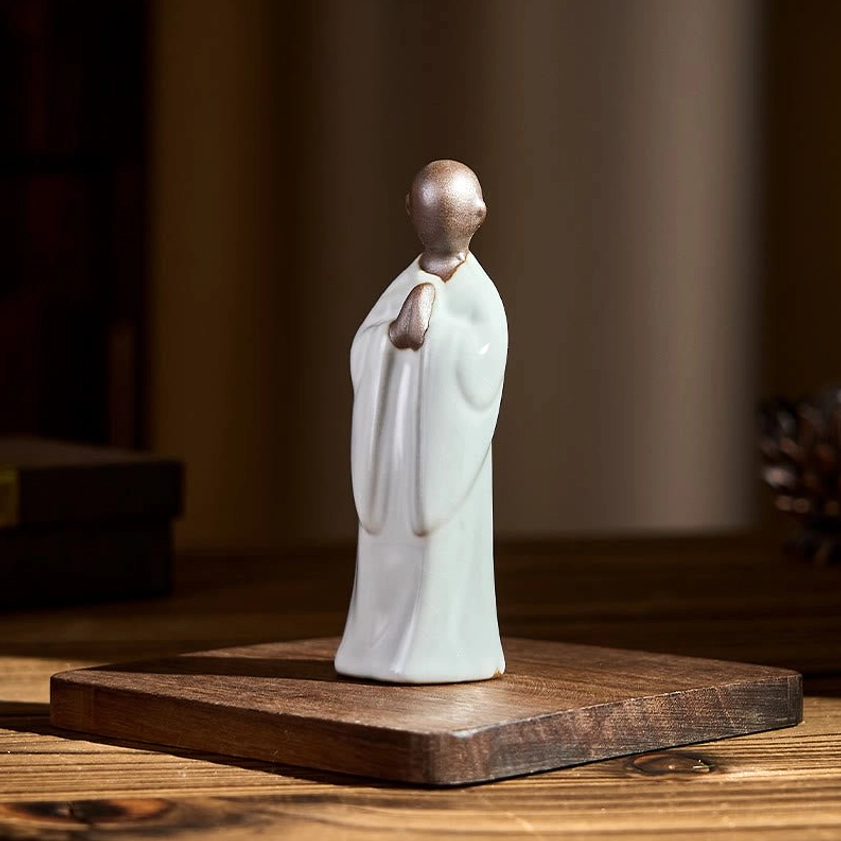 Ceramic meditation monk statue serene expression contemplative pose detail view